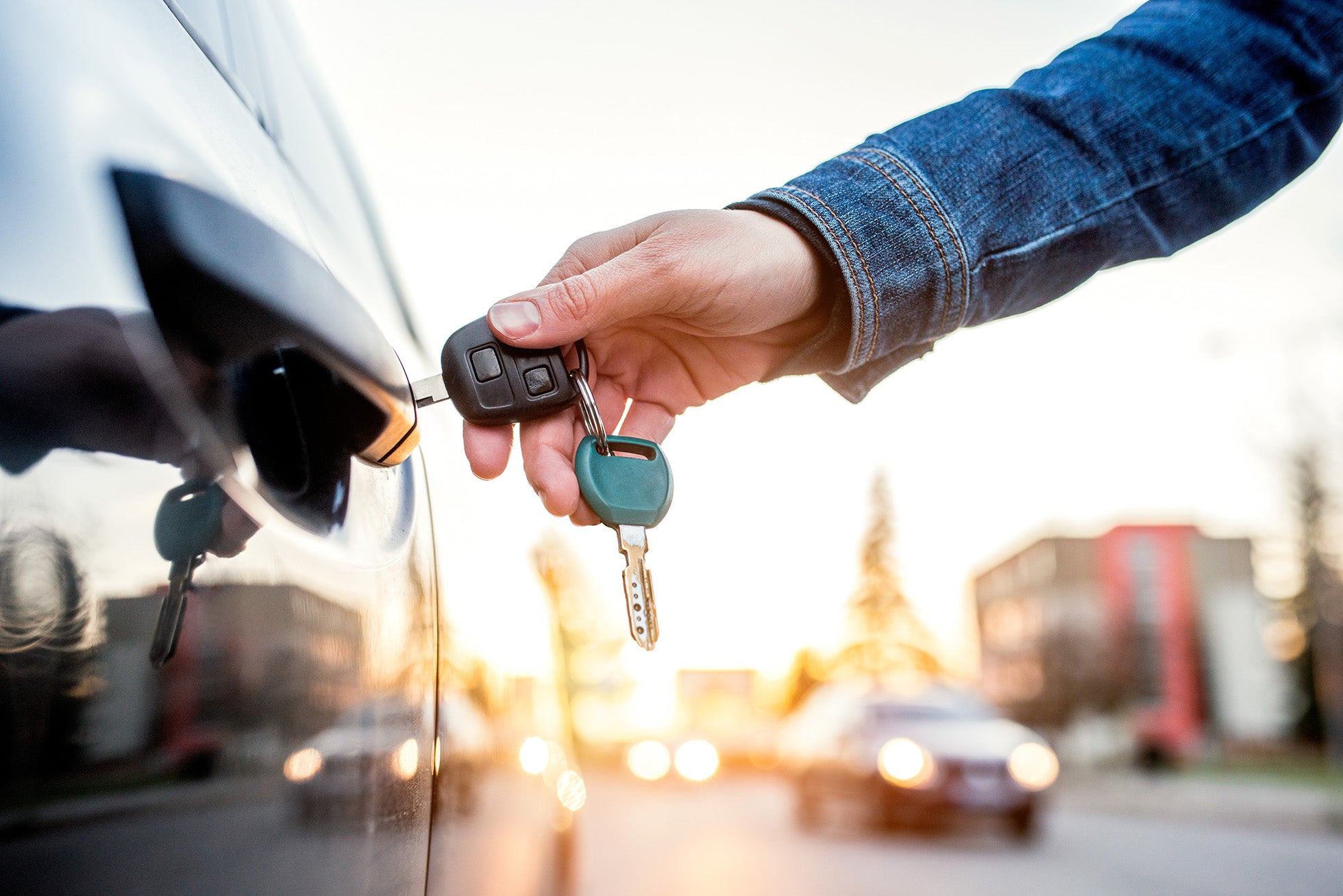 man putting keys in car
